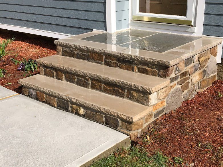 A set of stone steps leading up to a house.