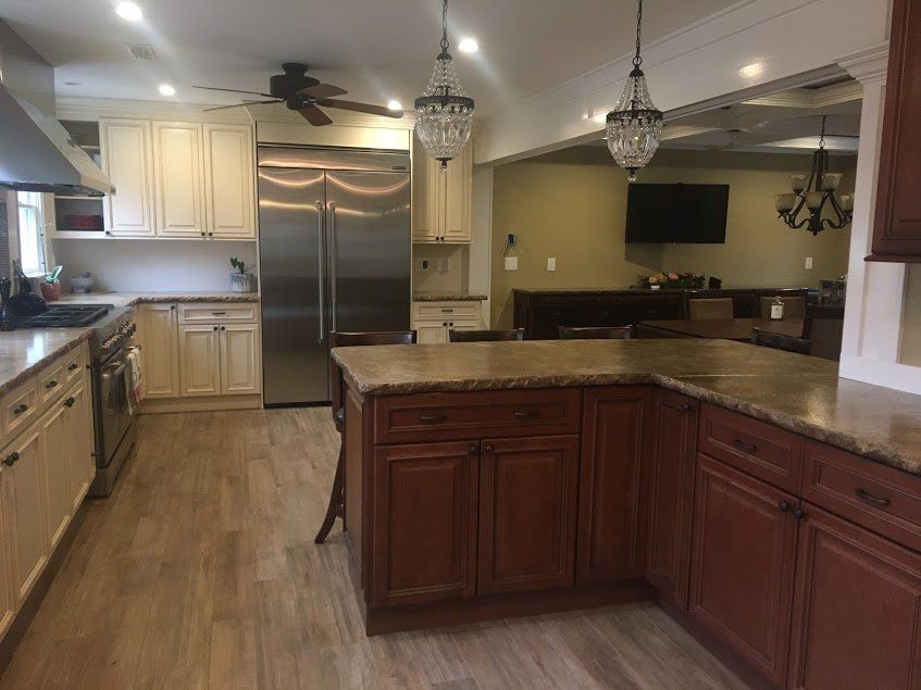 A kitchen with stainless steel appliances and wooden cabinets.