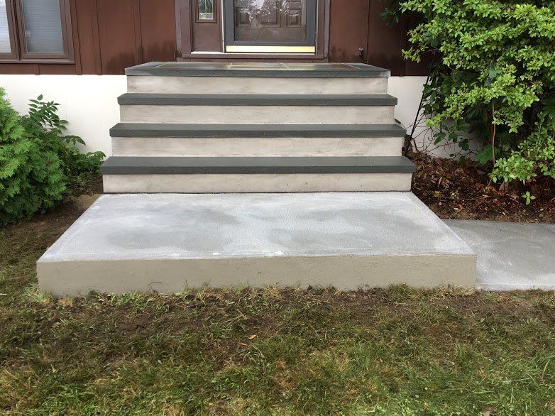 A set of concrete steps leading up to a house.