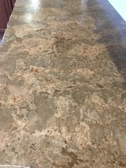 A close up of a marble counter top in a kitchen.