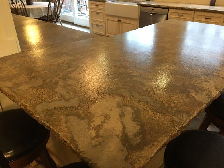 A kitchen counter with a marble counter top and a sink.