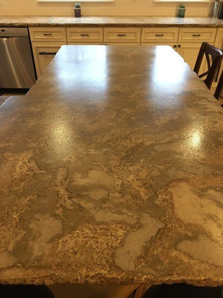 A kitchen counter with a marble counter top and a stainless steel dishwasher