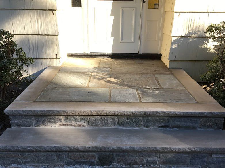 A stone walkway leading to the front door of a house