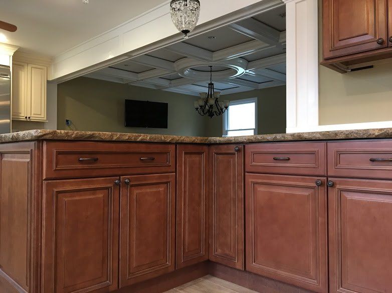 A kitchen with wooden cabinets and a granite counter top.