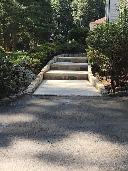 A set of stairs leading up to a house surrounded by trees