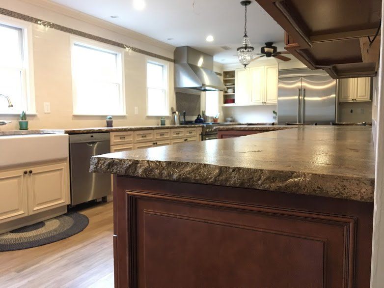 A kitchen with stainless steel appliances and granite counter tops
