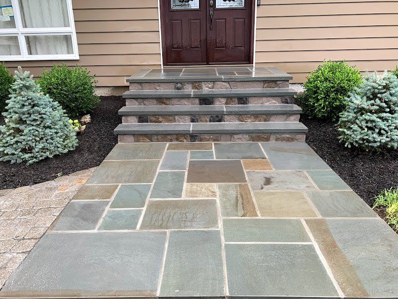 A stone walkway leading to the front door of a house