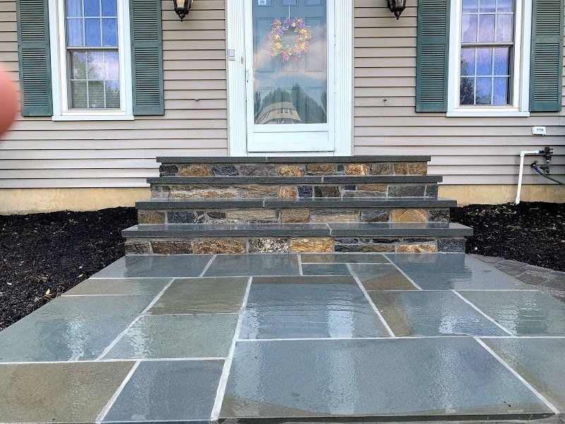 A stone walkway leading to the front door of a house