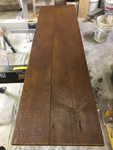 A long piece of wood is sitting on top of a table.