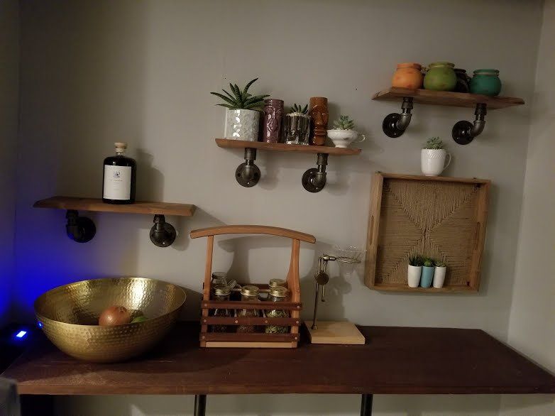 A wooden table with a bowl and a bottle on it.