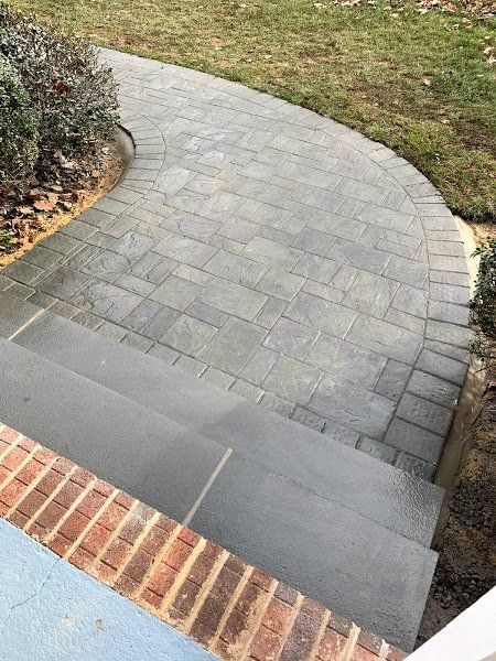 A brick walkway with stairs leading up to it.