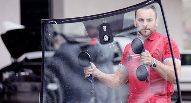 Man moving glass Windshield Repair