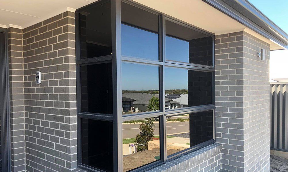A brick building with a large window on the side of it.