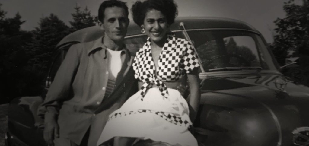 Vintage family photo with an old car in the background