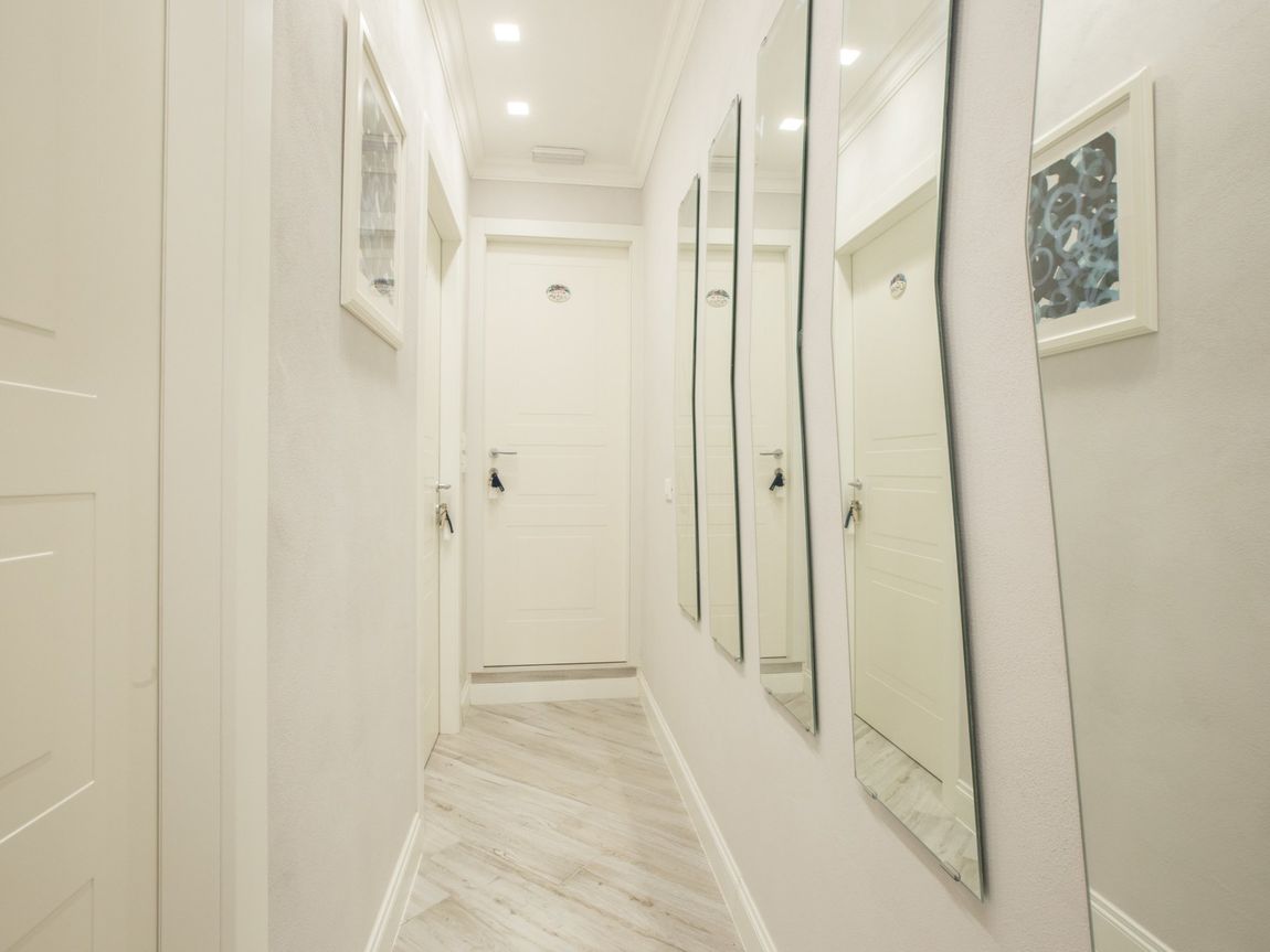 Corridor with doors and mirrors