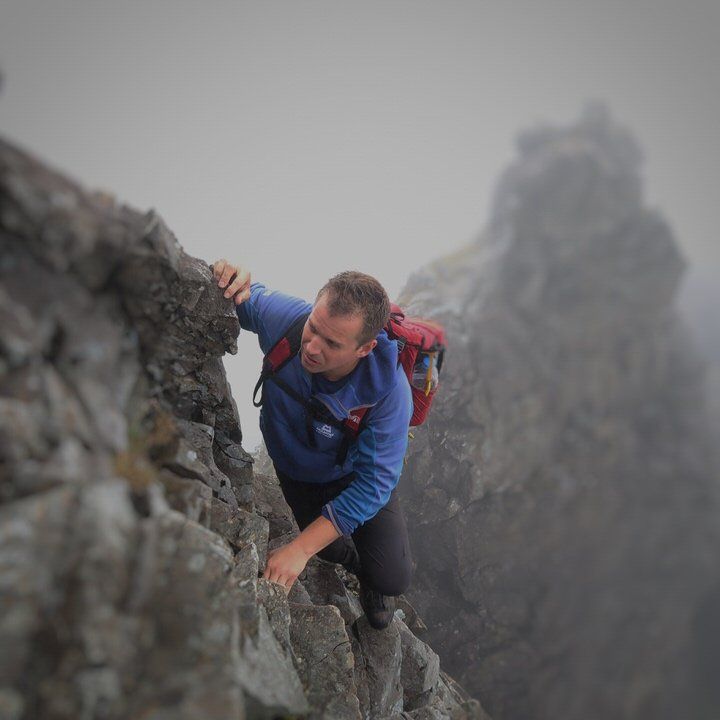 Scrambler climbing rocks on Cuillin Ridge