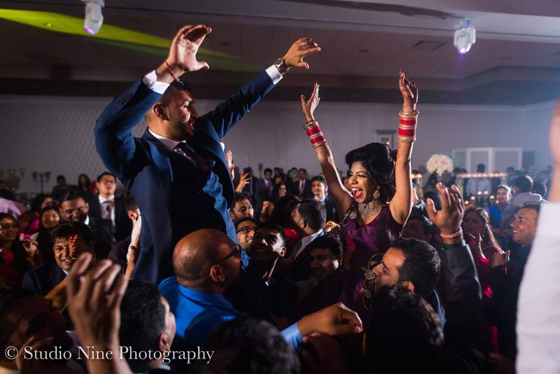bride and groom raised up