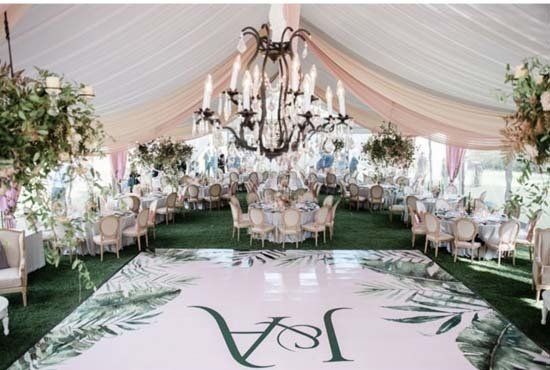 party tent with chandelier and monogram on dance floor