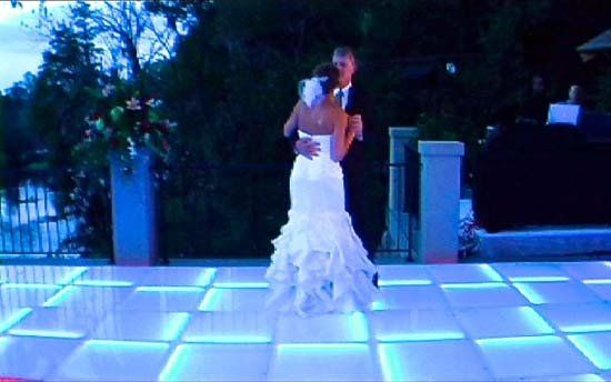 bride and groom dancing on light up dance floor