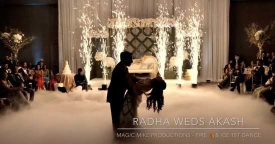 fog and firework effects in ballroom for wedding with bride and groom dancing