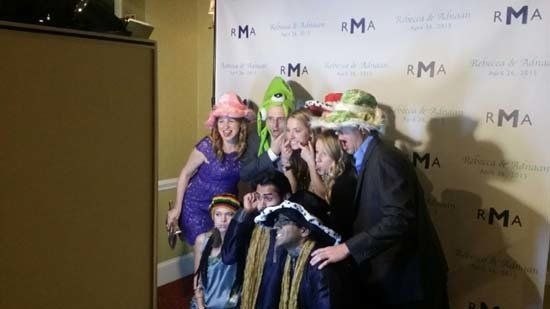 group of people posing for a photo booth photo