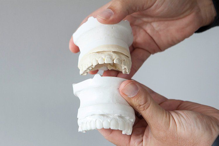 person holding dentures