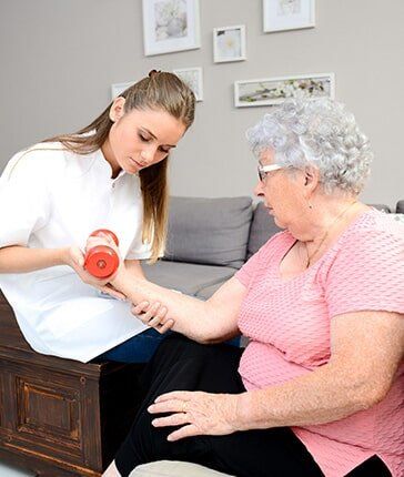 Assisting the elderly woman in exercising - Physical Therapy in Chadds Ford, PA