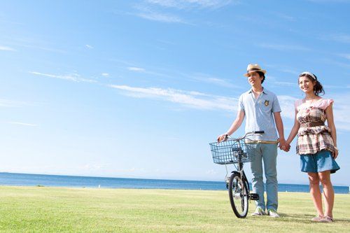 Young couple holding hands by a bicycle young couple holding hands by a bicycle