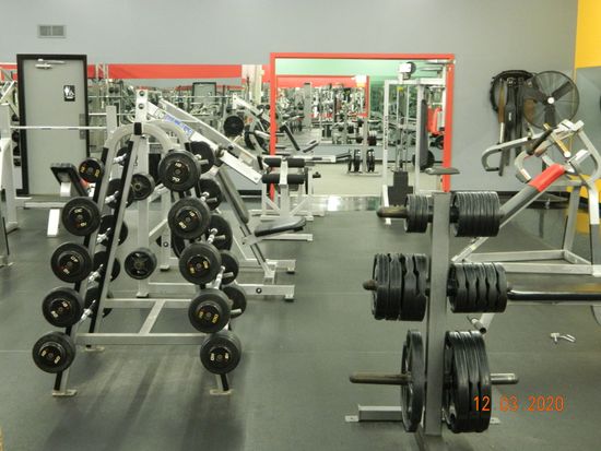 Man And Woman Lifting Barbells — Sandusky, OH — Health & Strength Gym