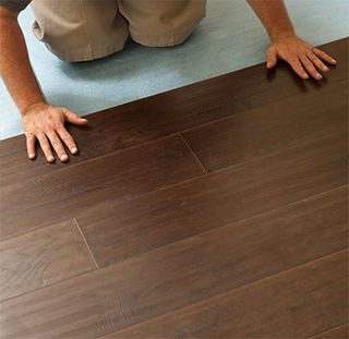 Man Installing Laminate Floor - Laminate in Jefferson, MA Man Installing Laminate Floor - Laminate in Jefferson, MA