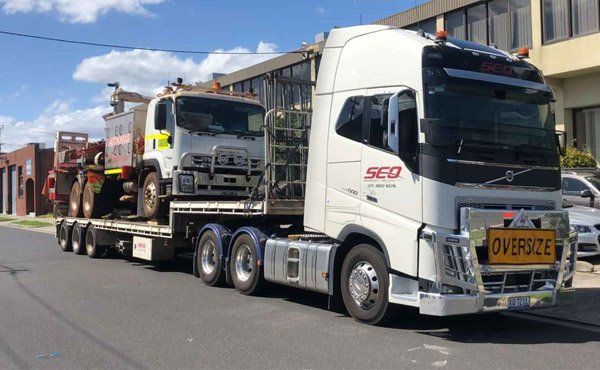 Truck on trailer of larger truck