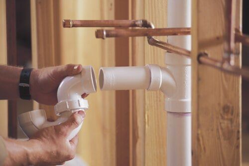Plumber connecting PVC pipes - plumbing in Elkhart County, IN One of our plumbers doing a sewer cleaning service in Goshen, IN