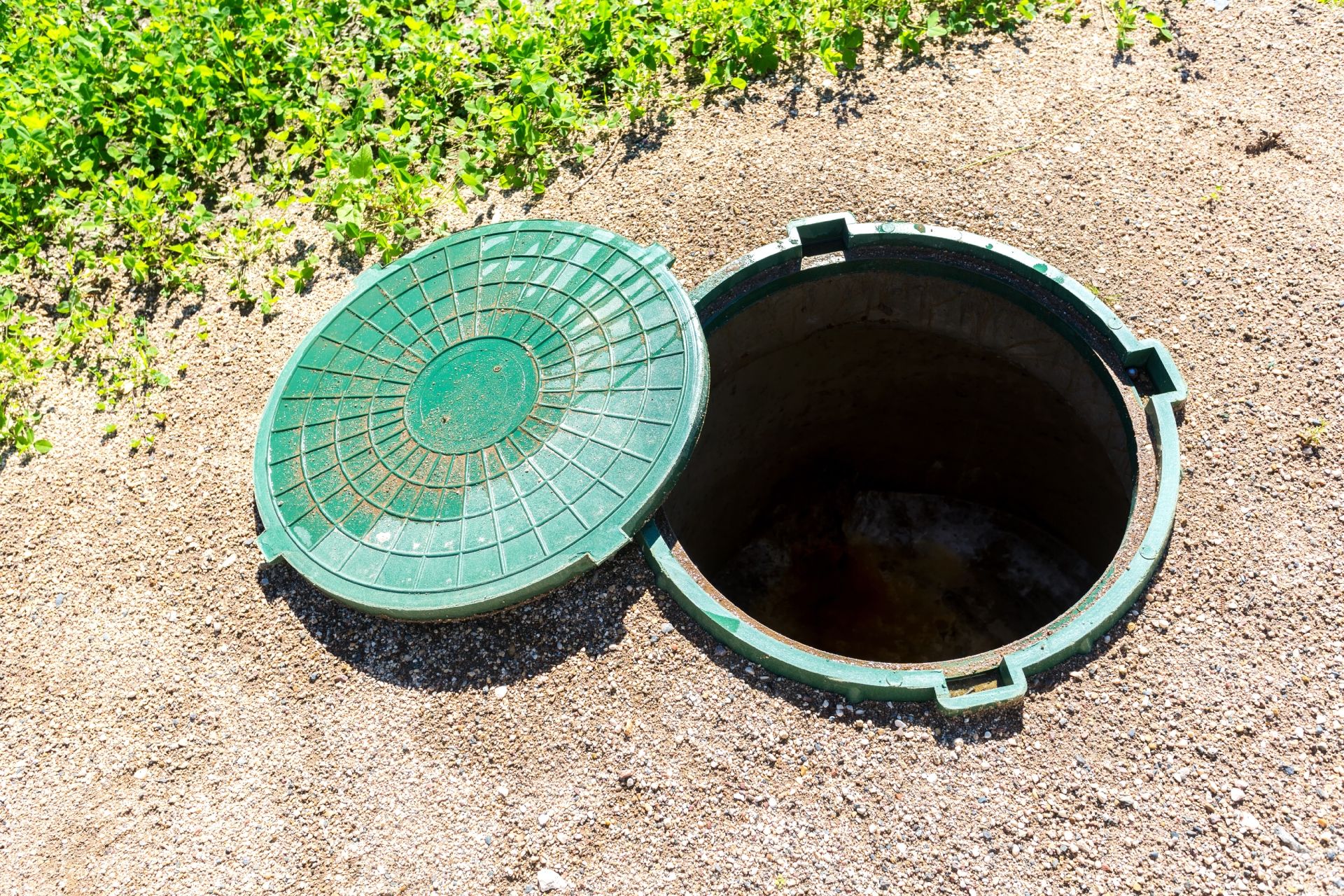 view of an open septic tank cover