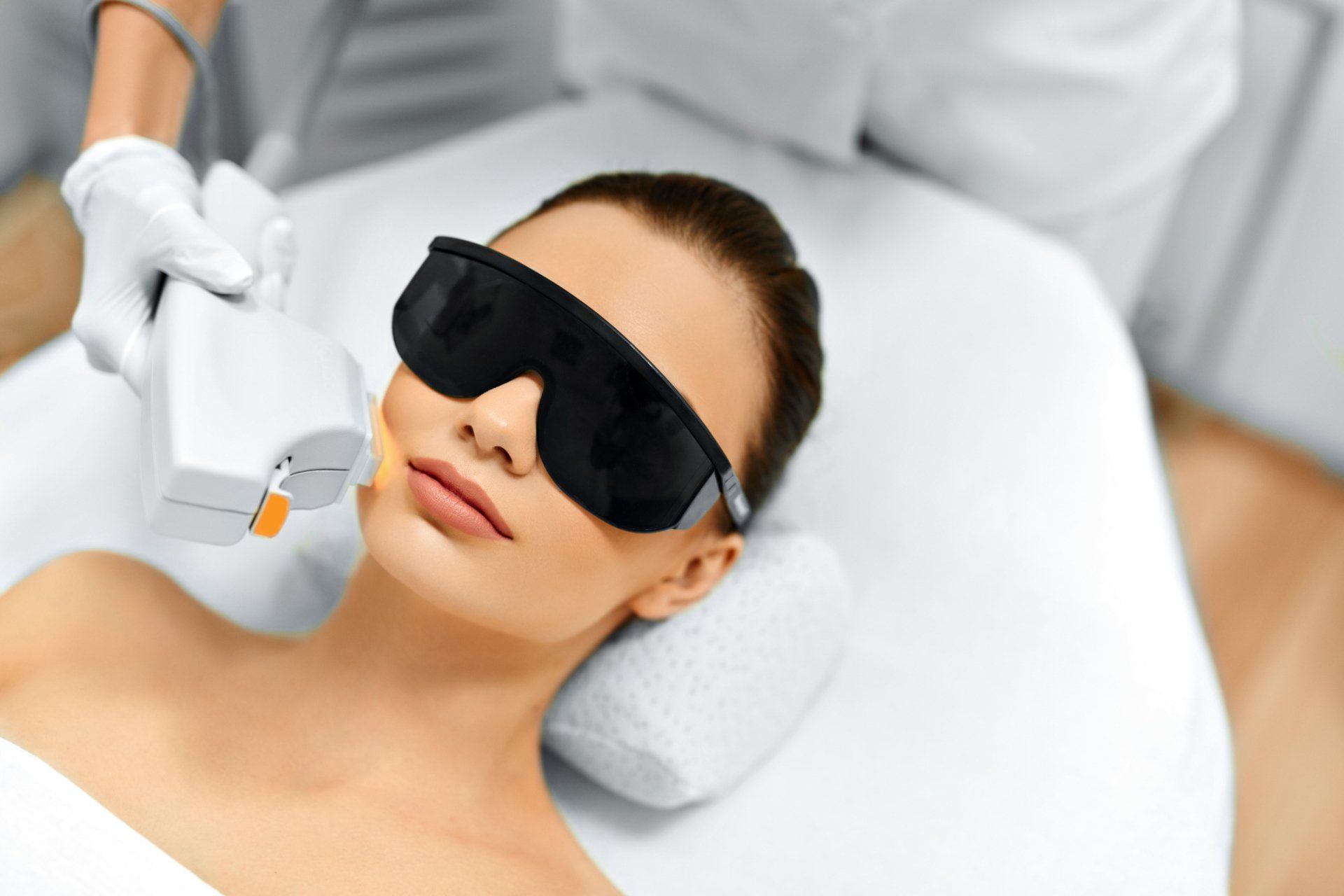 Woman in protective glasses receiving Intense Pulse Light treatment at Hot Springs Surgery and Vein Woman in protective glasses receiving Intense Pulse Light treatment at Hot Springs Surgery and Vein
