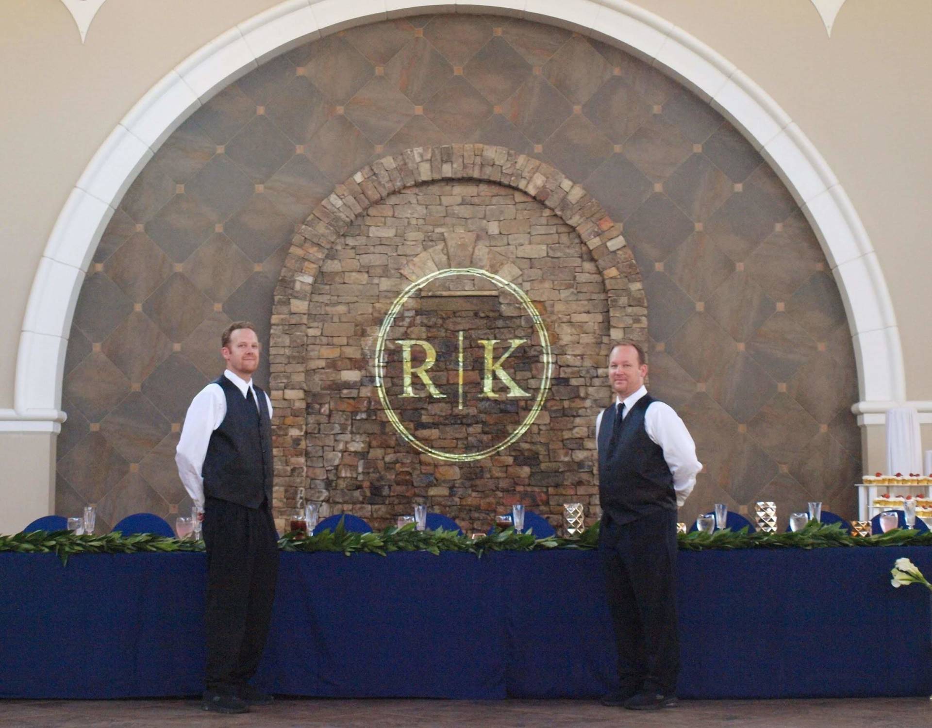 caterers posing in front of a wedding party table