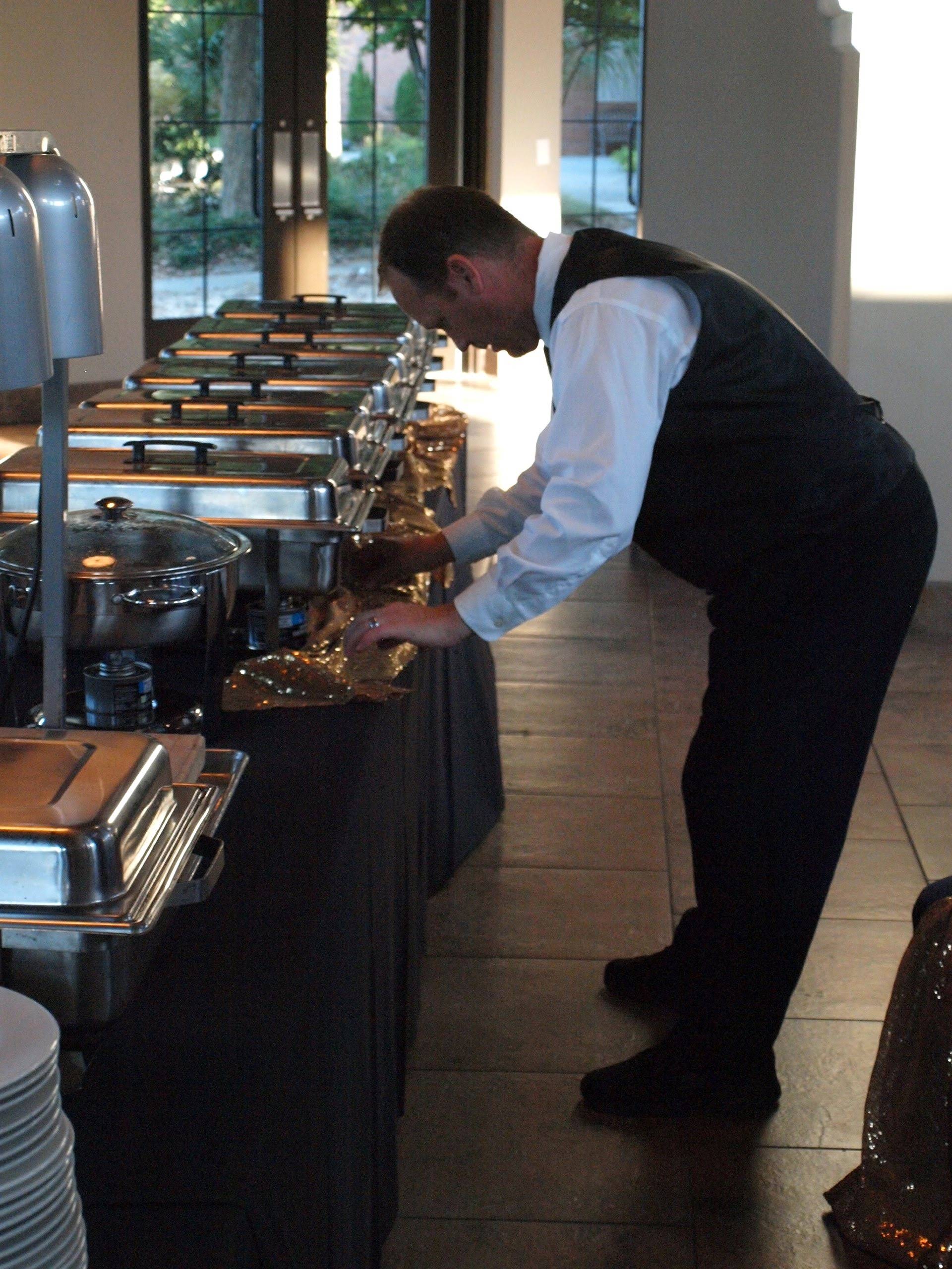 caterer setting up a buffet table