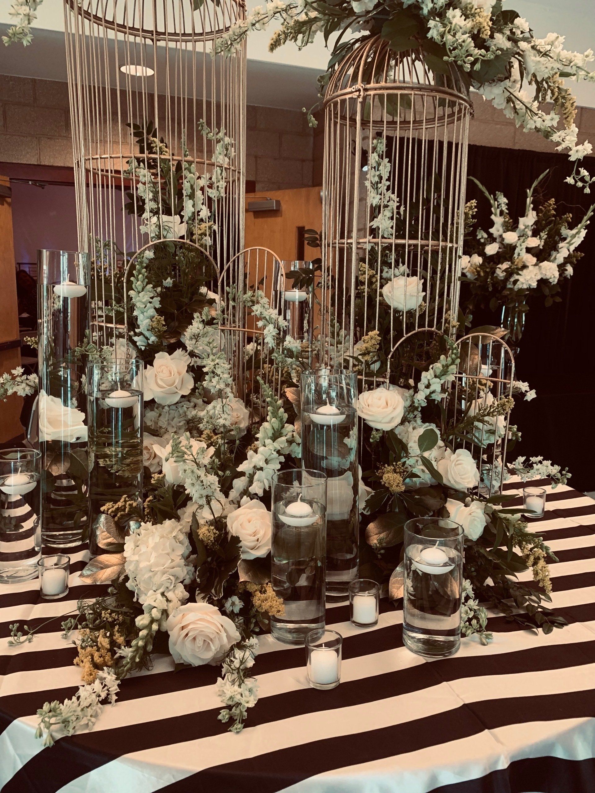 large floral display on table with black and white covering