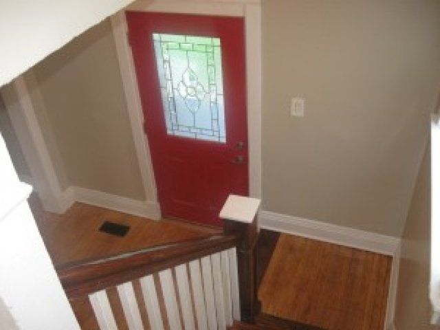 View of front door from stairway in 3308 Webster St, DiBar Enterprises.