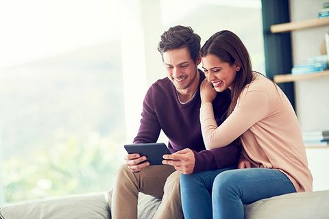 Couple looking at tablet.