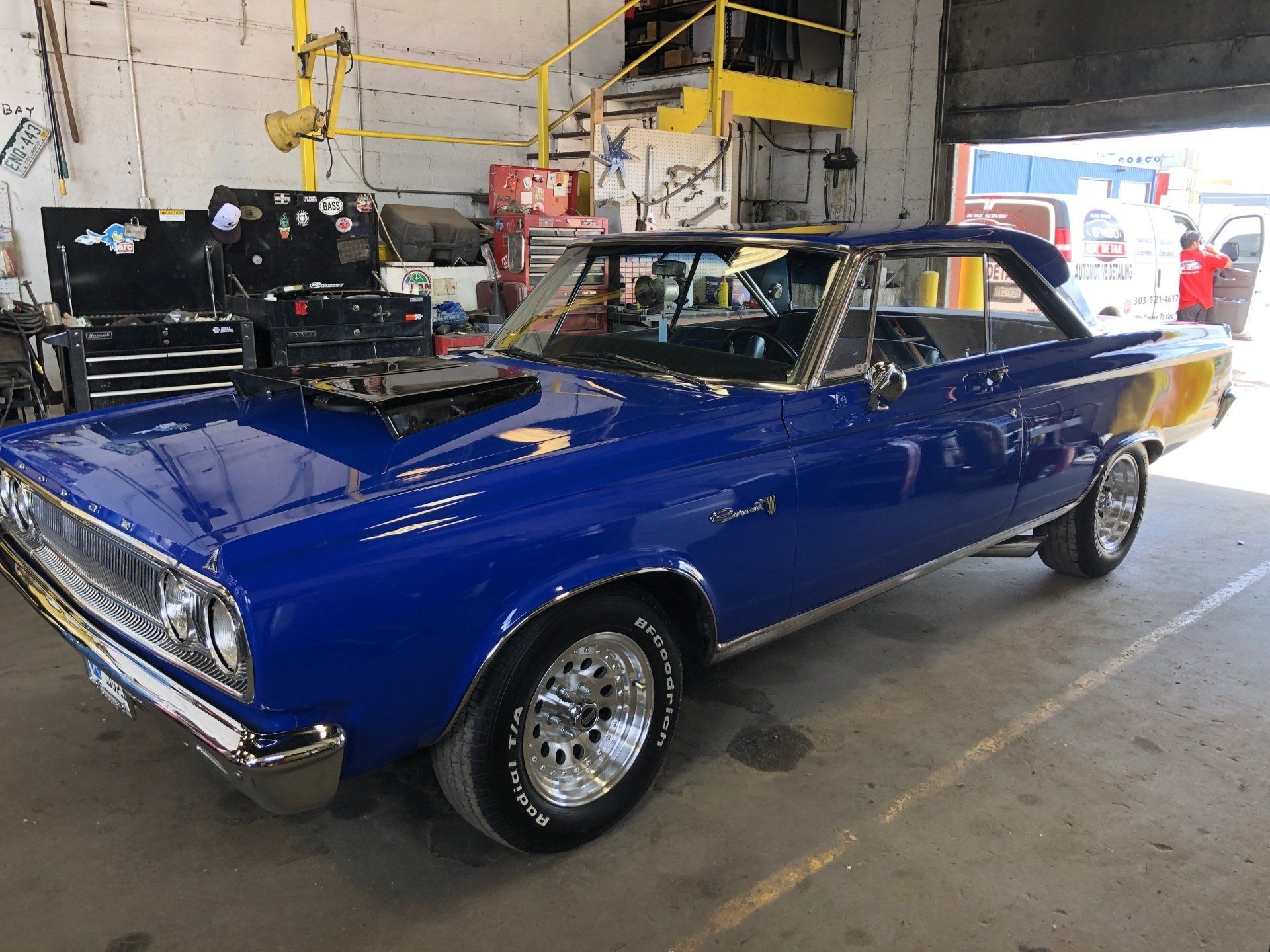 a blue dodge coronet parked in a garage
