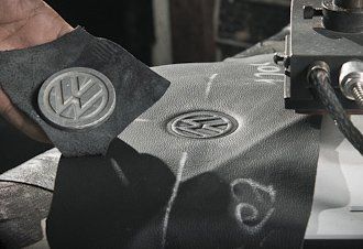 Uma pessoa está segurando um pedaço de papel com o logotipo da VW.