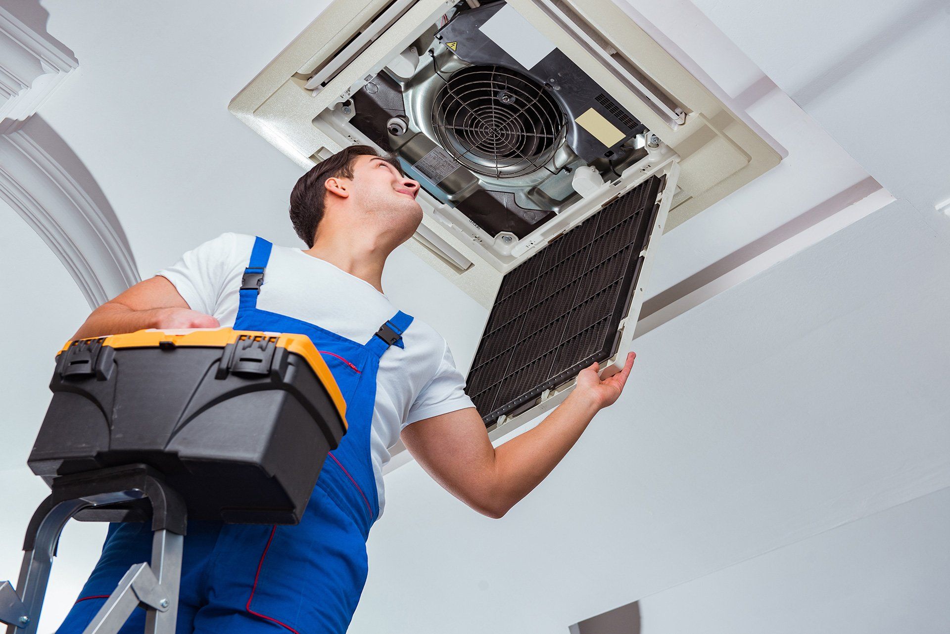 hvac technician inspecting a commercial hvac system - Ace Air Conditioning