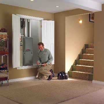 hvac technician inspecting an hvac system - Ace Air Conditioning