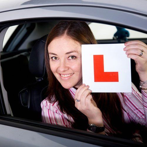 female inside a car learning to drive - studio; Shutterstock ID 8896282; PO: N/A; Job: BULK; Client: N/A; Other: BULK
