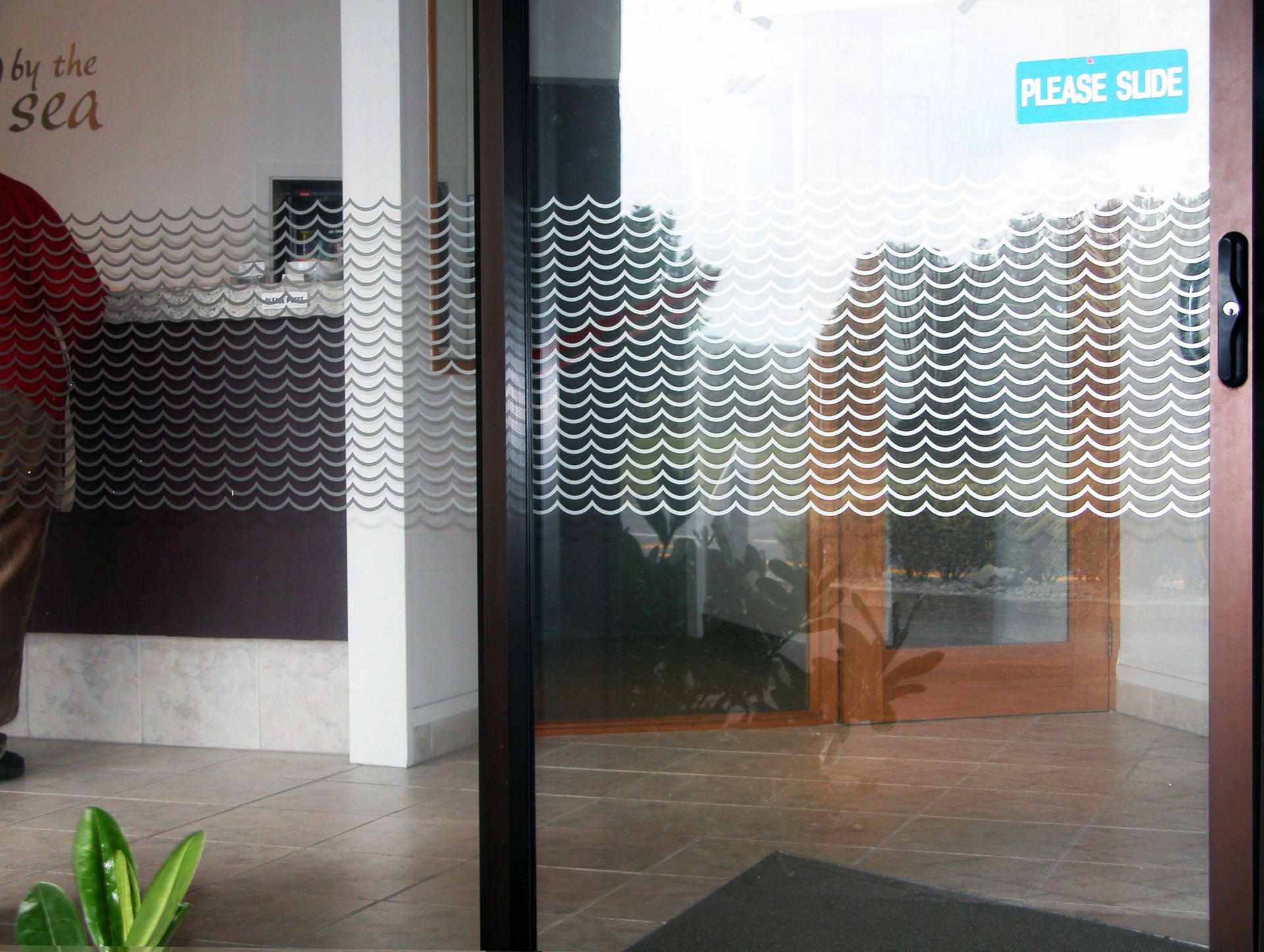 Window etch film with graphic design applied to windows