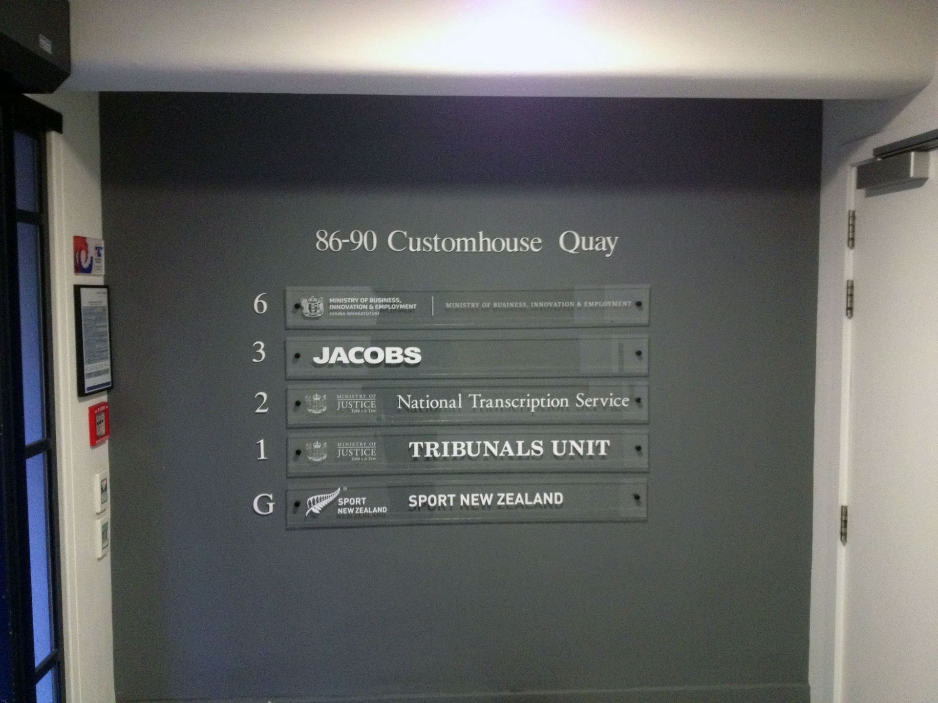 White computer cut vinyl lettering applied to clear acrylic directory panels