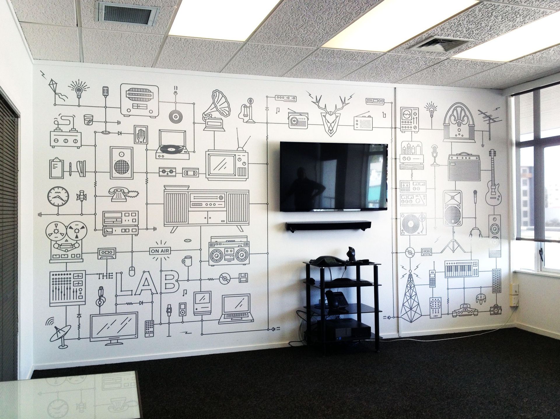 Computer cut vinyl graphics applied to meeting room wall