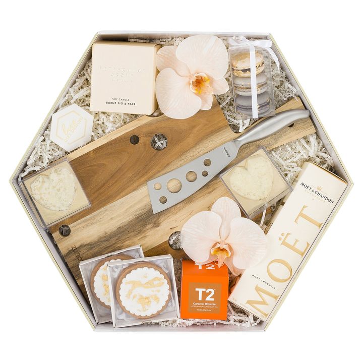 White box  with scented candles and macarons