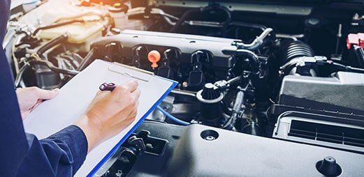 Mechanic Man Checking Car Engine — Auto Maintenance in Denver, CO Mechanic Man Checking Car Engine — Auto Maintenance in Denver, CO
