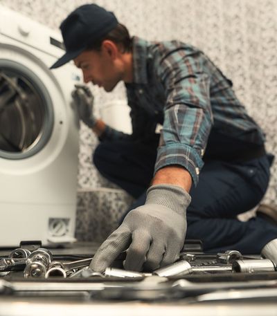 Technician Checking Dyer — Dyer, IN — Anderson Appliance Repair Technician Checking Dyer — Dyer, IN — Anderson Appliance Repair